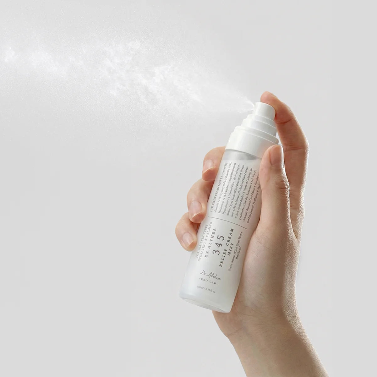 Hand spraying Dr. Althea 345 Relief Cream Mist in a fine, even mist