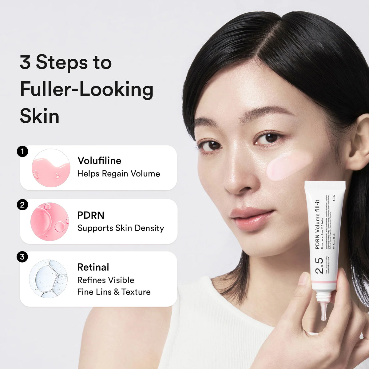 Woman holding the Abib PDRN Volume Fill-it tube by her cheek, with Volufiline, PDRN and retinal